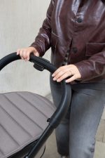 iCandy Peach 7 Porcini holding pram CU 2 scaled 2